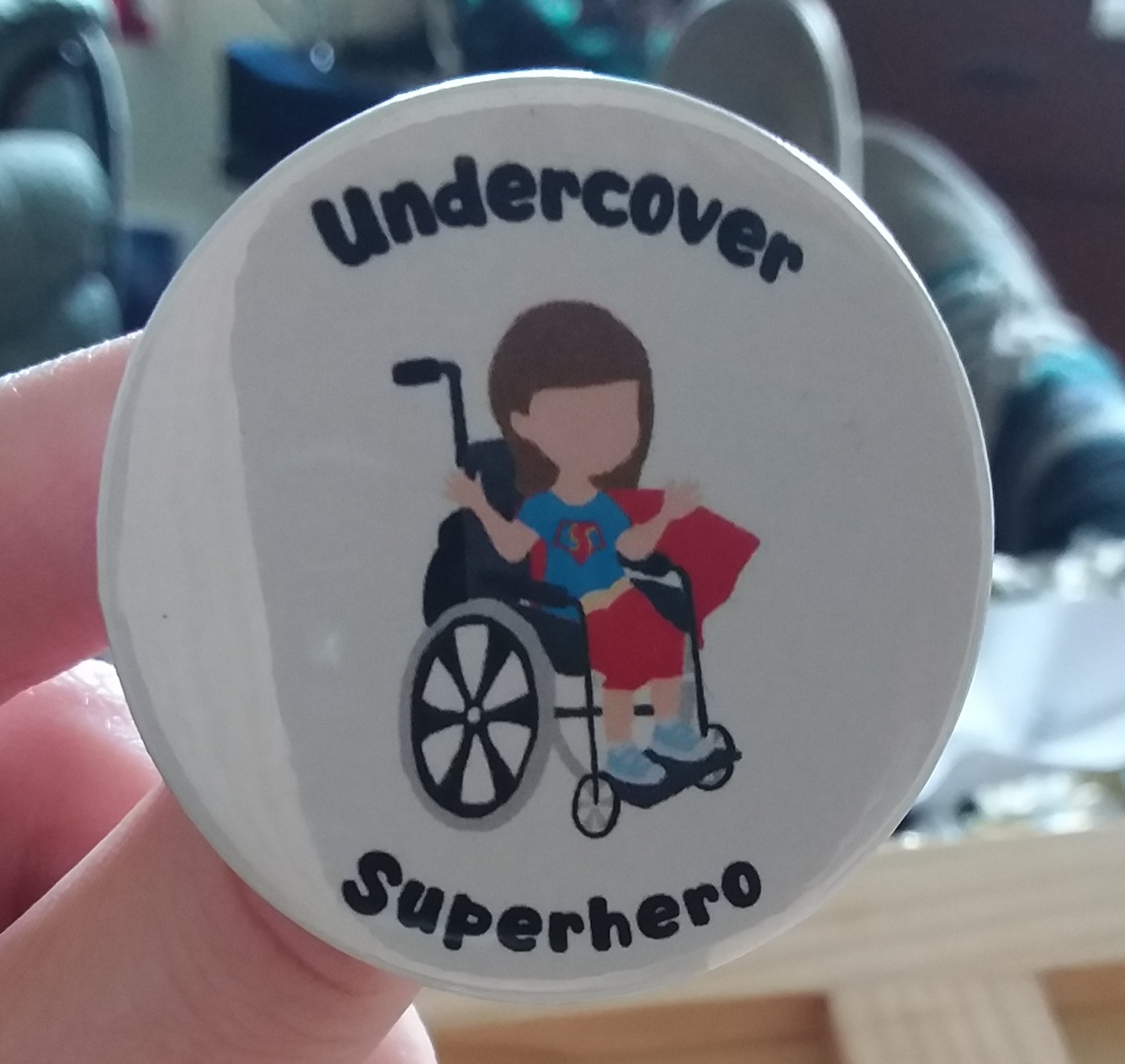 A white badge with the Undercover Superhero logo.