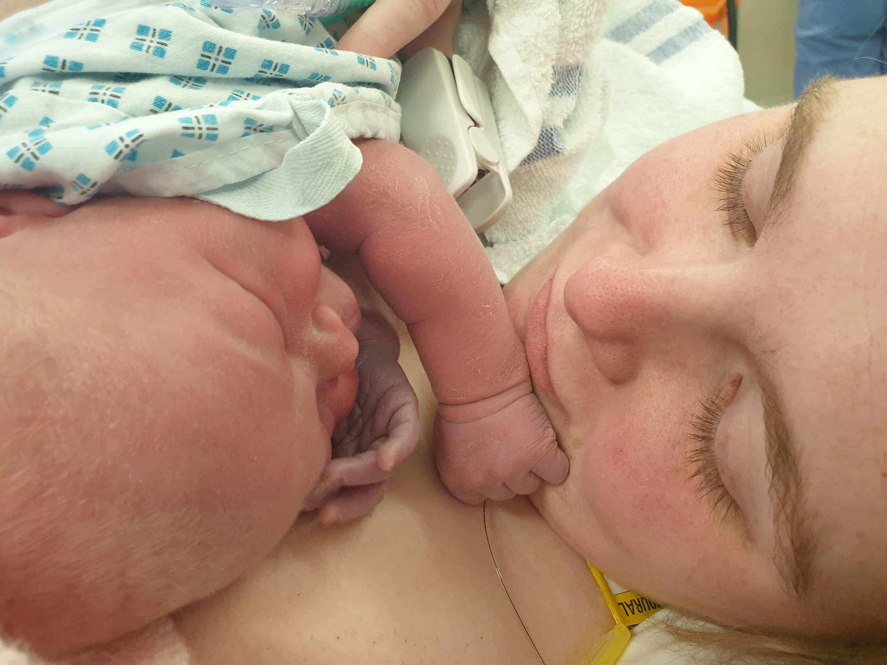 Photo of Ami cuddling Little Avenger for the first time
