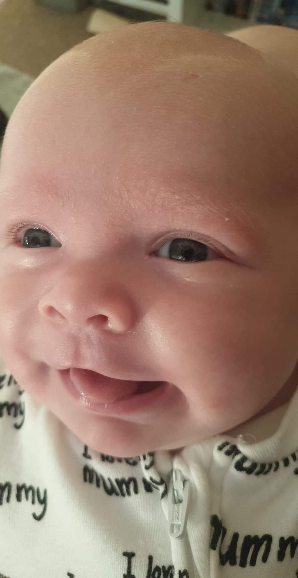 Close up photo of Daisy giving a cheeky little smile
