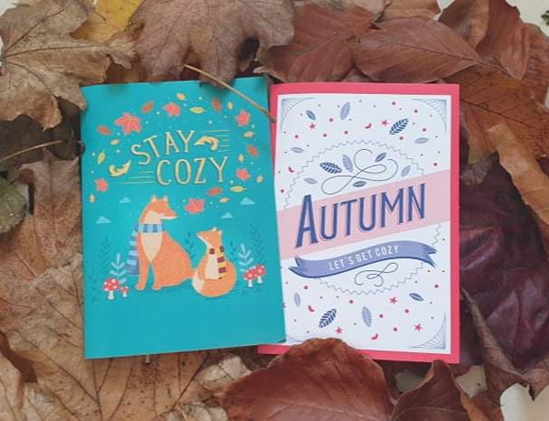 2 autumn themed notebooks laid on top of leaves