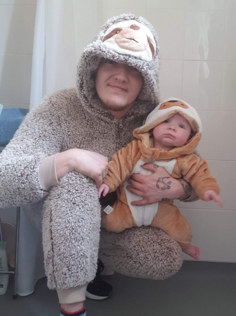 Daddy and Daisy in their sloth onesies