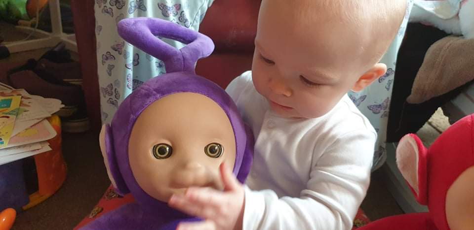 Daisy holding Tinky Winky (the purple teletubby)