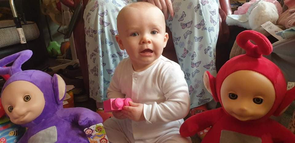 Daisy sitting with Tinky Winky and Po, two of the teletubbies