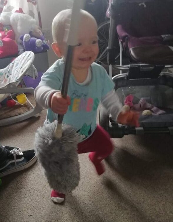 Daisy holding a duster