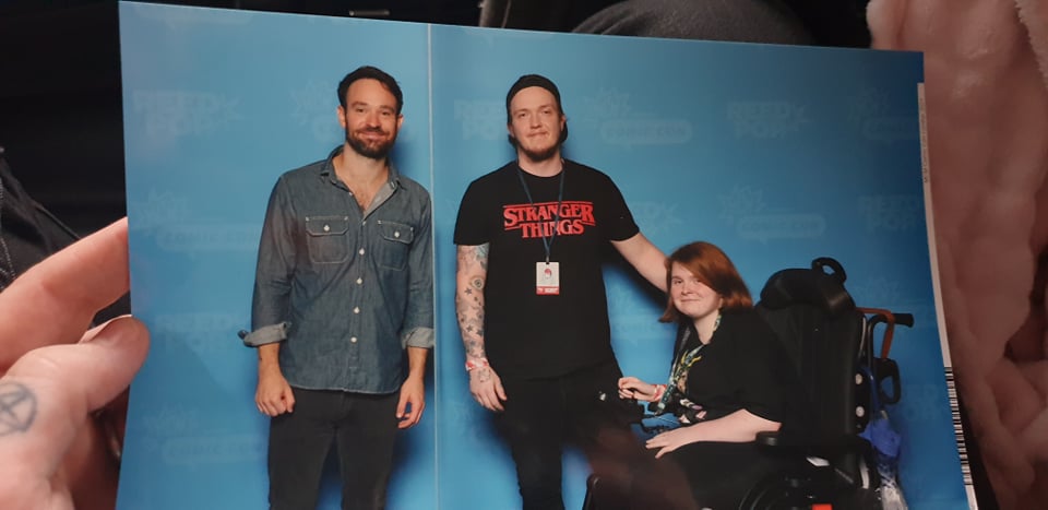 Ewan holding a photo where we met Charlie Cox
